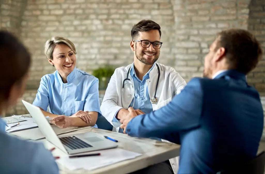 Healthcare professionals consulting with a patient in a clinical setting, highlighting the importance of reliable medical supplies and professional support from a Medical Supply Store.