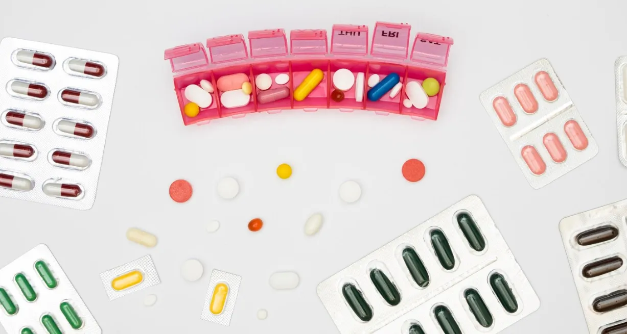 Weekly pill organizer with blister-packed medications demonstrating special packaging that simplifies medication schedules and supports adherence.
