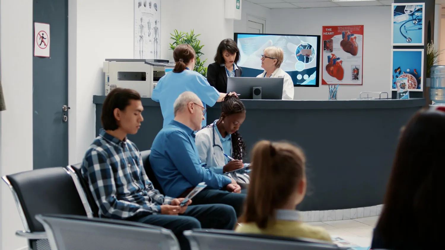 Patients waiting while healthcare professionals assist visitors at a modern wellness center in Jacksonville, providing preventive care, health services, and pharmacy support