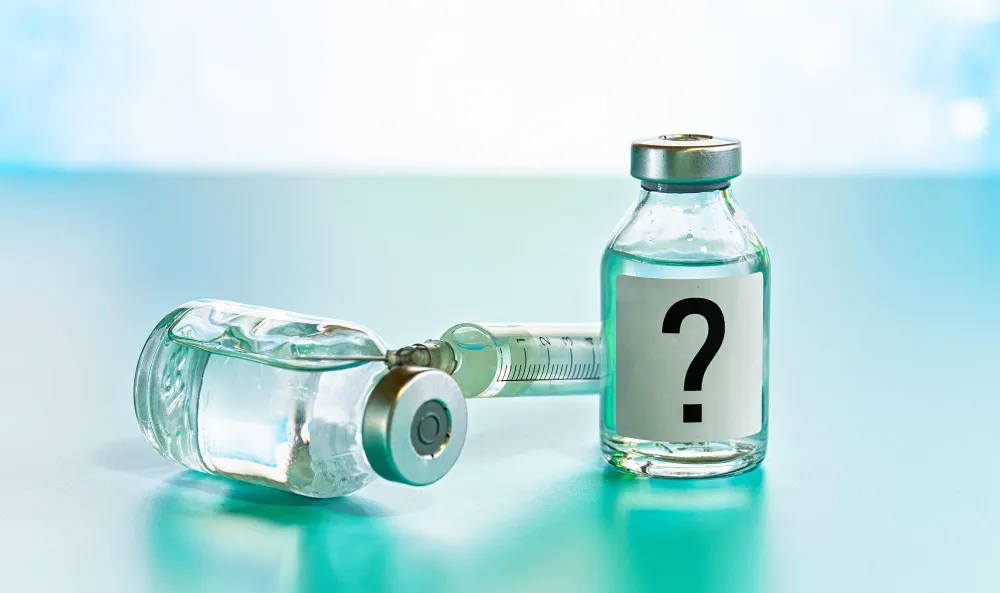 Vaccine vial with a question mark representing common pharmacy vaccine myths.