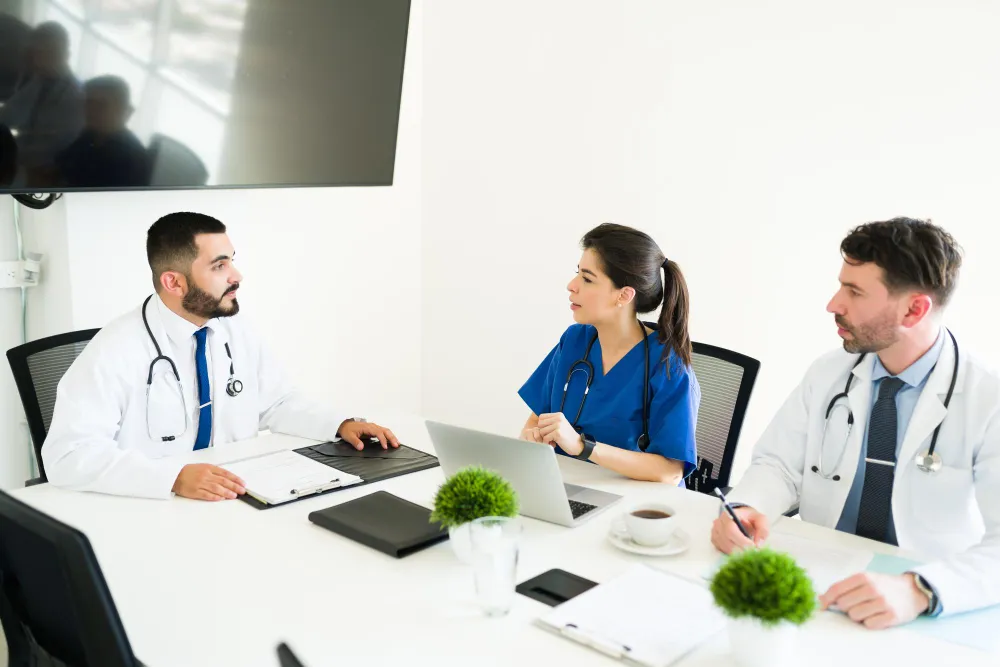 Medical professionals meeting to coordinate patient care and wellness programs, highlighting integrated healthcare services and wellness centers in Jacksonville