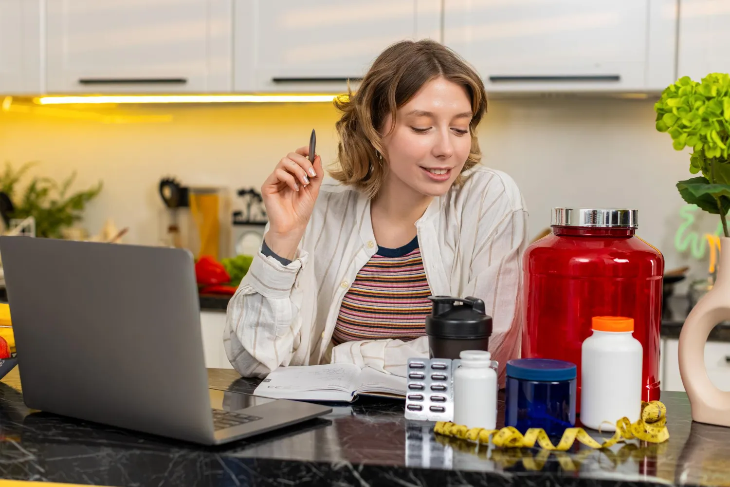 Woman reviewing nutrition notes with supplement bottles and protein containers, representing a vitamin and supplement store experience and smart selection of vitamin supplements for daily wellness