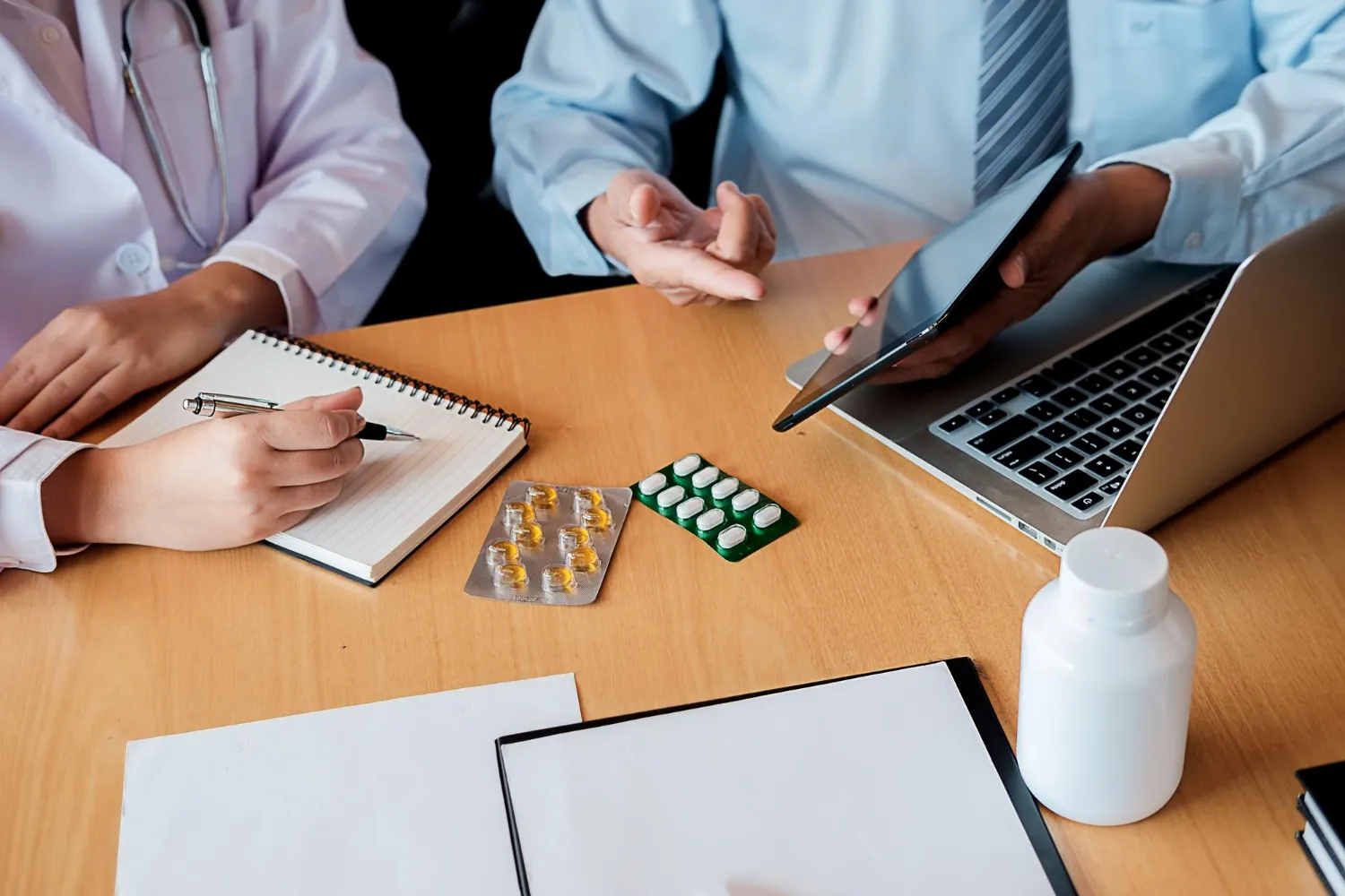 Healthcare provider reviewing vitamin supplements and medications to ensure proper intake and safe vitamin use for adults