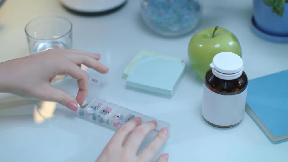Weekly pill organizer and medication setup, representing pharmacy pill packaging and organized medication management