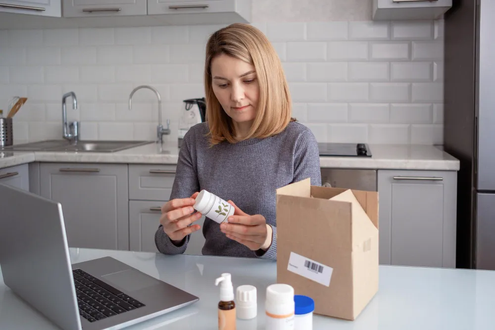 Patient reviewing packaged medications at home, highlighting travel medications packing and convenient pill packs pharmacy solutions