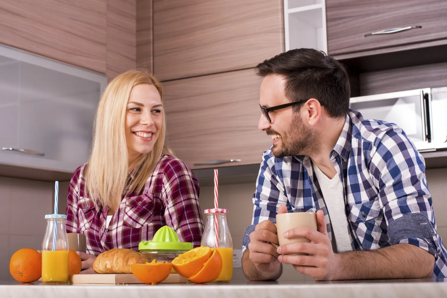 Couple enjoying a healthy breakfast with fresh juice and fruits, representing everyday wellness choices supported by a trusted vitamin pharmacy or local supplement store