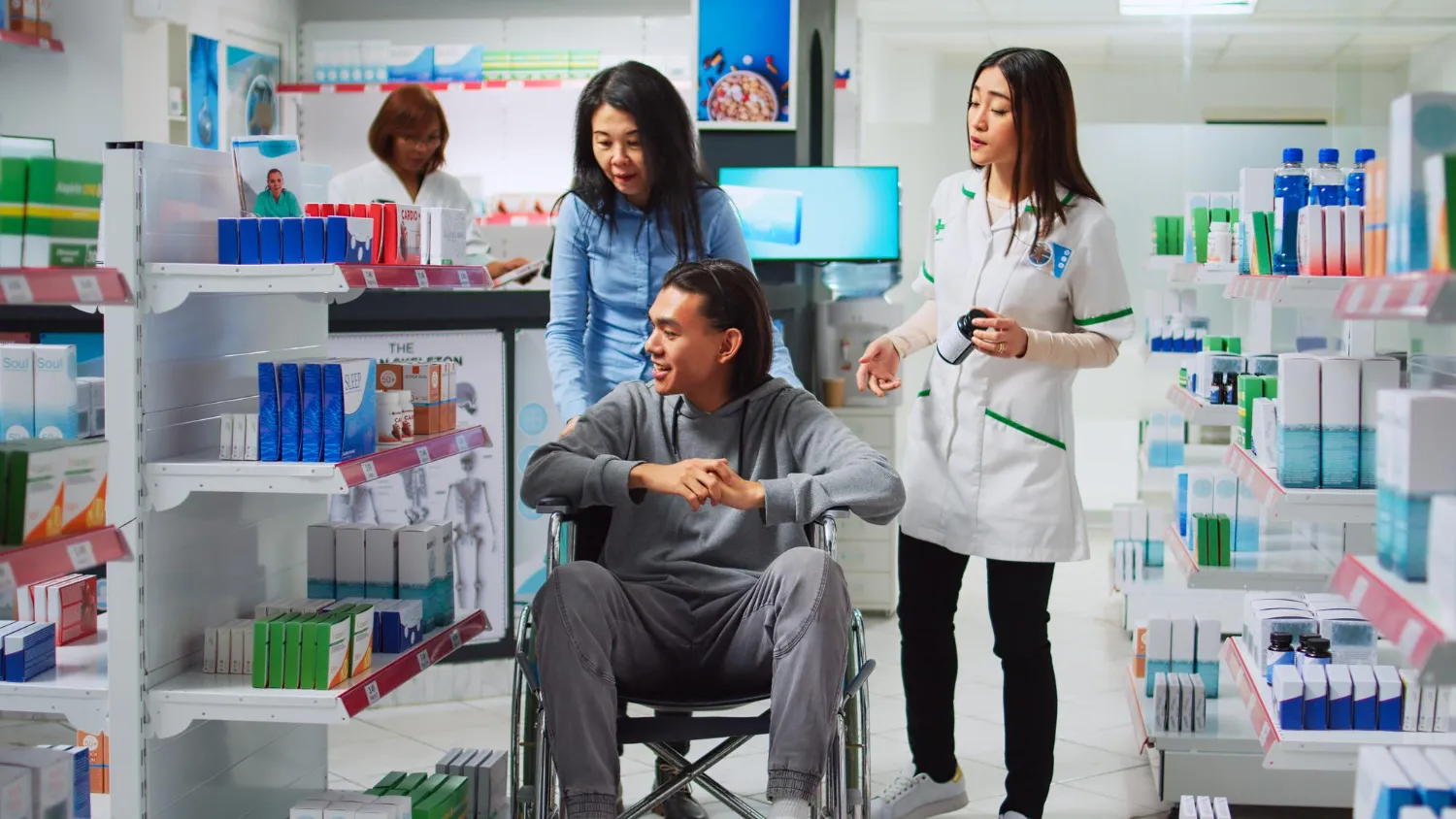 Medical supply pharmacy in Jacksonville FL assisting patient in wheelchair with prescription products and healthcare supplies
