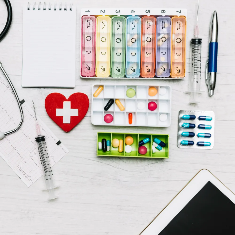 Medical supply pharmacy products including pill organizers, syringes, and medications for patient care and daily health management