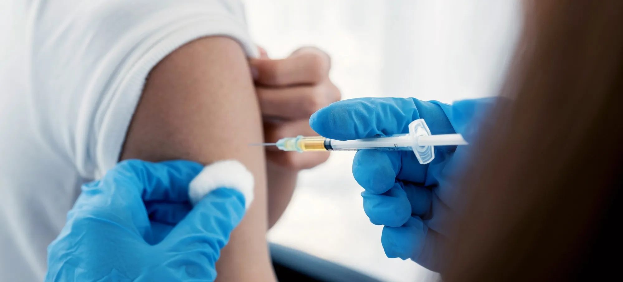 Medical professional preparing and administering a vaccine as part of Immunization At Work, helping employees stay protected through convenient workplace vaccination programs.