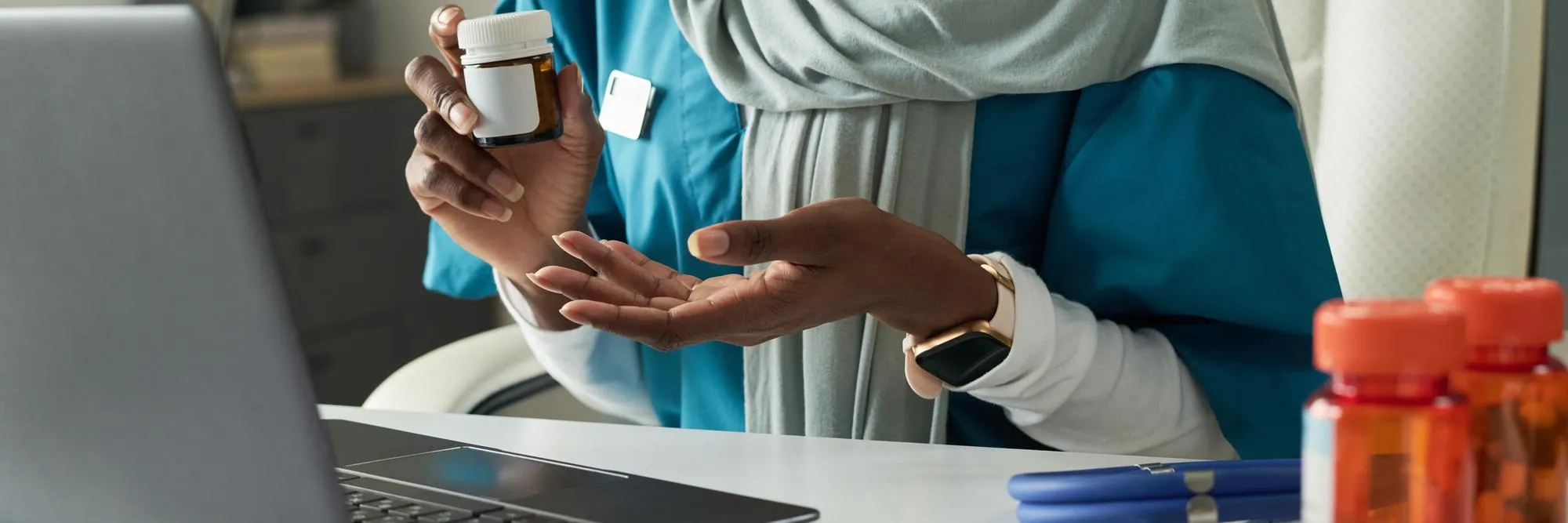 Patient holding a prescription bottle during a medication synchronization consultation, reviewing refill schedules through medication synchronization services to simplify monthly prescriptions.