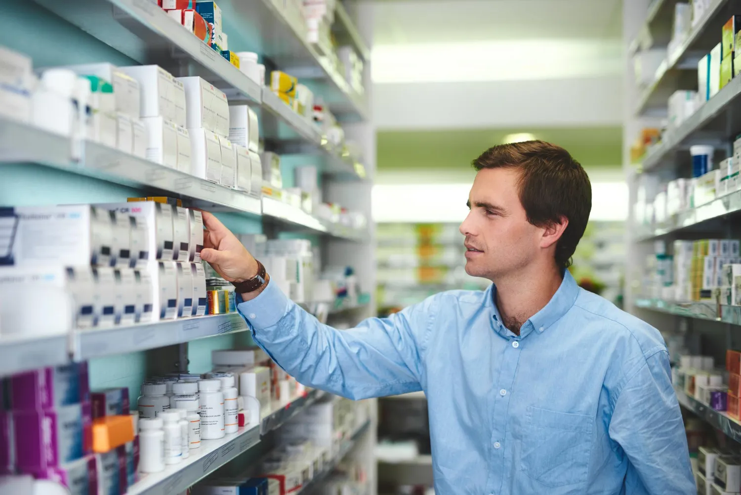 Pharmacy professional organizing medicines for medication packaging services.