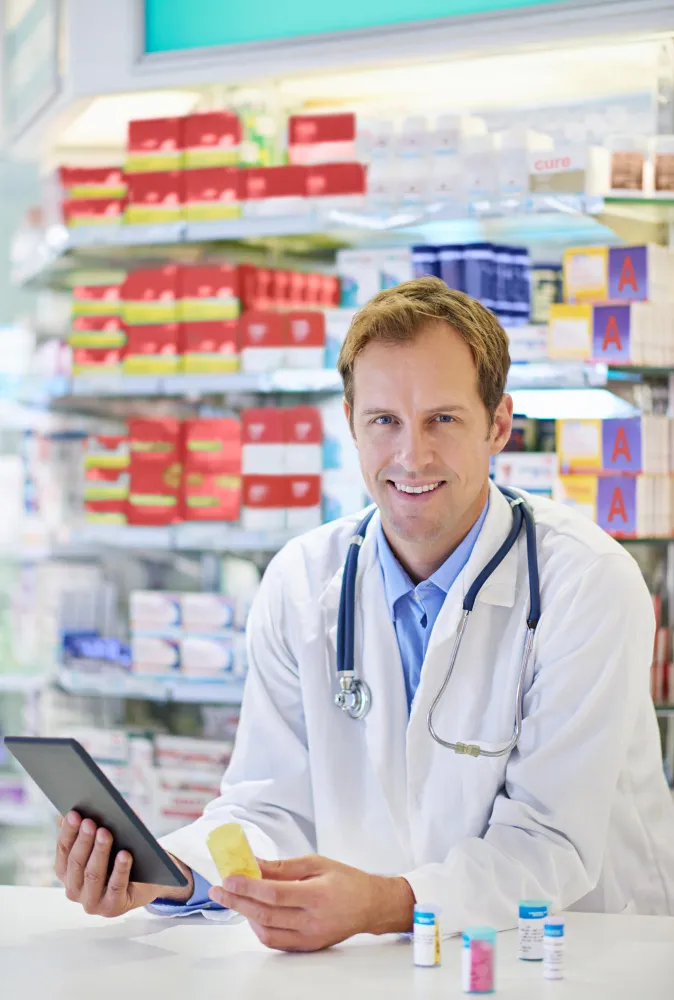 Pharmacist reviewing prescription medications as part of prescription medication packaging.